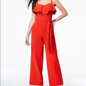 Ruffled belted red jumpsuit.